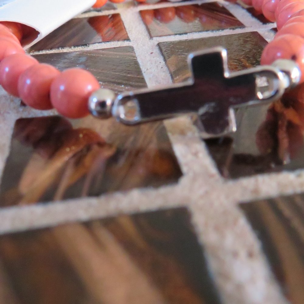 BRACELET- SALMON COLOR BEAD WITH A SILVER CROSS